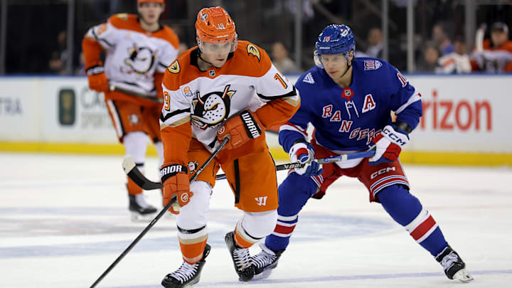 Dec 15, 2025; New York, New York, USA; Anaheim Ducks right wing Troy Terry (19) skates with the puck against New York Rangers left wing Artemi Panarin (10) during the third period at Madison Square Garden. Mandatory Credit: Brad Penner-Imagn Images