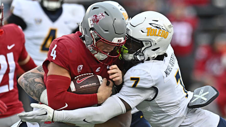 Washington State QB Zevi Eckhaus is wrapped up by Toledo Rockets safety Emmanuel McNeil-Warren, a potential first-round pick.
