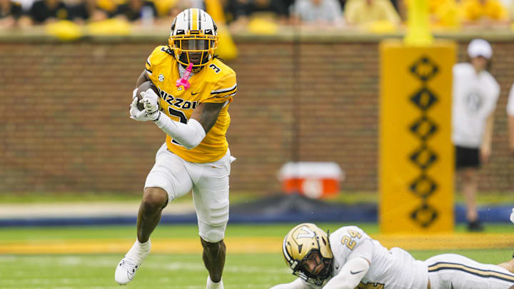 Sep 21, 2024; Columbia, Missouri, USA; Missouri Tigers wide receiver Luther Burden III (3) returns a punt against Vanderbilt Commodores linebacker Nicholas Rinaldi (24) during the first half at Faurot Field at Memorial Stadium. Mandatory Credit: Jay Biggerstaff-Imagn Images