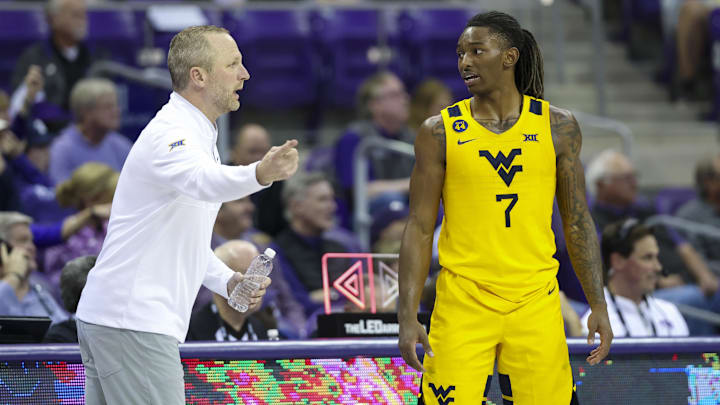 Feb 5, 2025; Fort Worth, Texas, USA;  West Virginia Mountaineers guard Javon Small (7) speaks with West Virginia Mountaineers head coach Darian DeVries during the second half against the TCU Horned Frogs at Ed and Rae Schollmaier Arena. Mandatory Credit: Kevin Jairaj-Imagn Images