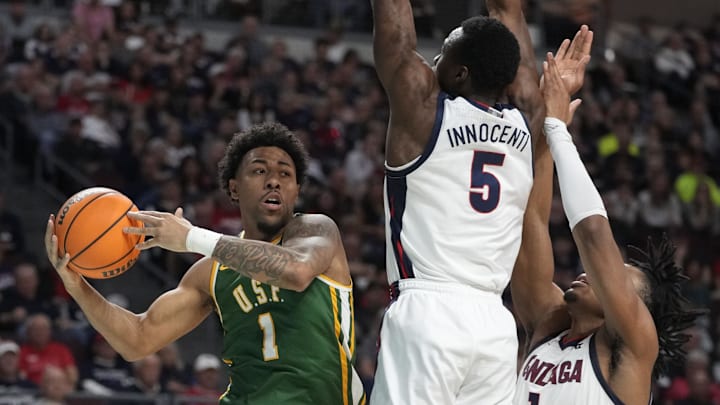 March 10, 2025; Las Vegas, NV, USA; San Francisco Dons guard Malik Thomas (1) is defended by Gonzaga Bulldogs forward Emmanuel Innocenti (5) and guard Michael Ajayi (1) during the second half in the semifinal of the West Coast Conference tournament at Orleans Arena. Mandatory Credit: Kyle Terada-Imagn Images March 10, 2025; Las Vegas, NV, USA; San Francisco Dons guard Malik Thomas (1) is defended by Gonzaga Bulldogs forward Emmanuel Innocenti (5) and guard Michael Ajayi (1) during the second half in the semifinal of the West Coast Conference tournament at Orleans Arena. Mandatory Credit: Kyle Terada-Imagn Images