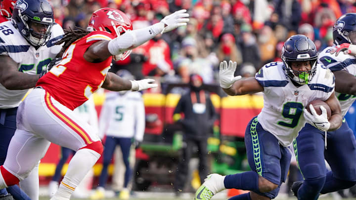 Dec 24, 2022; Kansas City, Missouri, USA; Seattle Seahawks running back Kenneth Walker III (9) runs the ball as Kansas City Chiefs linebacker Nick Bolton (32) defends during the second half at GEHA Field at Arrowhead Stadium. Mandatory Credit: Denny Medley-Imagn Images