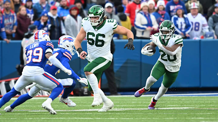 Dec 29, 2024; Orchard Park, New York, USA; New York Jets center Joe Tippmann (66) leads a block for running back Breece Hall (20) as Buffalo Bills cornerback Cam Lewis (39) tries to make a tackle in the fourth quarter at Highmark Stadium. Mandatory Credit: Mark Konezny-Imagn Images
