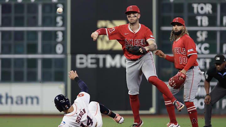 Sep 21, 2024; Houston, Texas, USA; Los Angeles Angels shortstop Zach Neto (9) turns a double play against Houston Astros left fielder Mauricio Dubon (14) in the fourth inning at Minute Maid Park. Mandatory Credit: Thomas Shea-Imagn Images