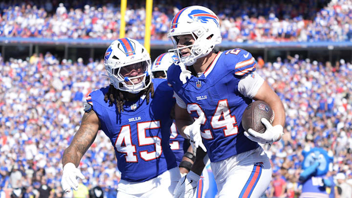 Sep 28, 2025; Orchard Park, New York, USA;  Buffalo Bills safety Cole Bishop (24) and outside linebacker Shaq Thompson (45) celebrate after intercepting a pass intended for New Orleans Saints quarterback Spencer Rattler (2)