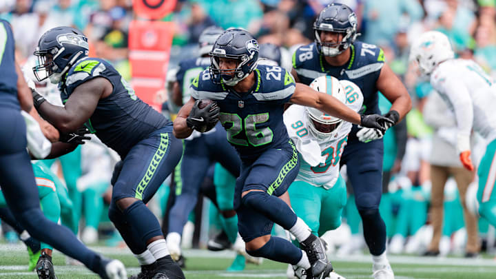 Sep 22, 2024; Seattle, Washington, USA; Seattle Seahawks running back Zach Charbonnet (26) runs with the ball during the second quarter against Miami Dolphins at Lumen Field. Mandatory Credit: Kevin Ng-Imagn Images Sep 22, 2024; Seattle, Washington, USA; Seattle Seahawks running back Zach Charbonnet (26) runs with the ball during the second quarter against Miami Dolphins at Lumen Field. Mandatory Credit: Kevin Ng-Imagn Images