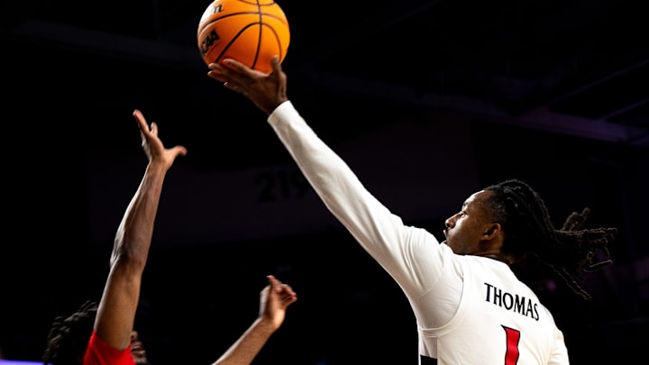 Cincinnati Bearcats guard Day Day Thomas (1) shoots a layup over Ohio State Buckeyes guard Bruce Thornton (2) in the second half of a basketball scrimmage between Cincinnati Bearcats and Ohio State Buckeyes at Fifth Third Arena in Cincinnati on Friday, Oct. 18, 2024. Cincinnati Bearcats guard Day Day Thomas (1) shoots a layup over Ohio State Buckeyes guard Bruce Thornton (2) in the second half of a basketball scrimmage between Cincinnati Bearcats and Ohio State Buckeyes at Fifth Third Arena in Cincinnati on Friday, Oct. 18, 2024.