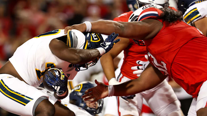 Sep 7, 2024; Tucson, Arizona, USA; Arizona Wildcats defensive lineman Chubba Ma'ae (92) goes in to tackle Northern Arizona Lumberjack running back Darvon Hubbard (23) during fourth quarter at Arizona Stadium. Mandatory Credit: Aryanna Frank-Imagn Images