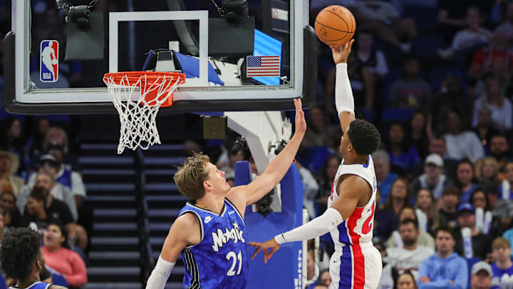 Mar 3, 2024; Orlando, Florida, USA; Detroit Pistons guard Jaden Ivey (23) attempts a shot against Orlando Magic center Moritz Wagner (21) during the first quarter at KIA Center. Mandatory Credit: Mike Watters-Imagn Images