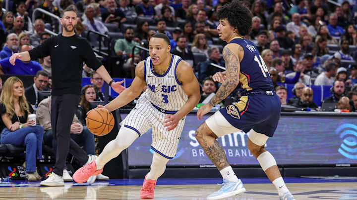 Jan 11, 2026; Orlando, Florida, USA; Orlando Magic guard Desmond Bane (3) drives past New Orleans Pelicans guard Micah Peavy (14) during the second half at Kia Center. Mandatory Credit: Mike Watters-Imagn Images