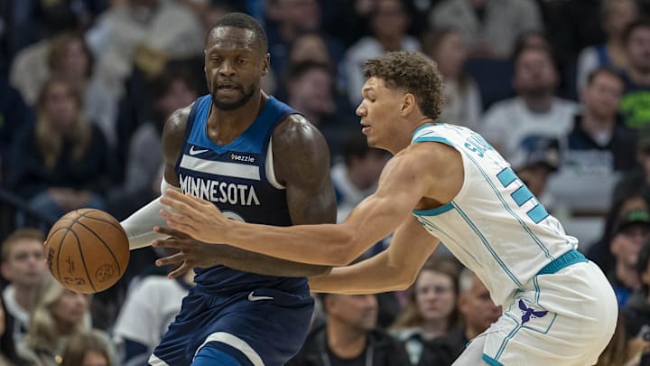 Nov 4, 2024; Minneapolis, Minnesota, USA; Minnesota Timberwolves forward Julius Randle (30) backs toward the basket as Charlotte Hornets forward Tidjane Salaun (31) plays defense in the second half at Target Center. Mandatory Credit: Jesse Johnson-Imagn Images