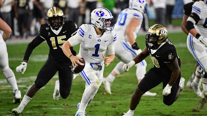 Dec 22, 2020; Boca Raton, Florida, USA; Brigham Young Cougars quarterback Zach Wilson (1) scrambles with the ball against the UCF Knights during the first half at FAU Stadium. Mandatory Credit: Jasen Vinlove-Imagn Images