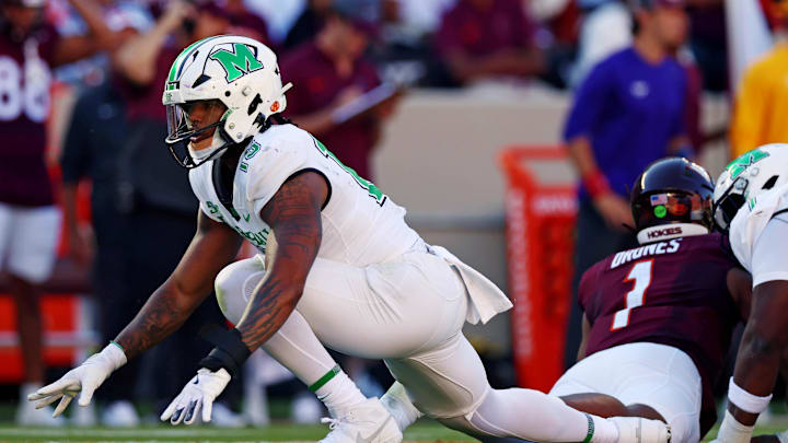 Sep 7, 2024; Blacksburg, Virginia, USA; Marshall Thundering Herd defensive lineman Mike Green (15) celebrates after sacking Virginia Tech Hokies quarterback Kyron Drones (1) during the first quarter at Lane Stadium. Mandatory Credit: Peter Casey-Imagn Images