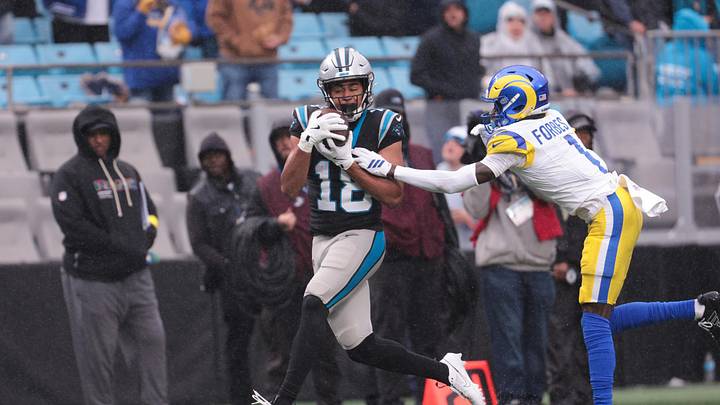Nov 30, 2025; Charlotte, North Carolina, USA;  Carolina Panthers wide receiver Jalen Coker (18) makes a catch as Los Angeles Rams cornerback Emmanuel Forbes Jr. (1) defends during the third quarter at Bank of America Stadium. Mandatory Credit: Scott Kinser-Imagn Images