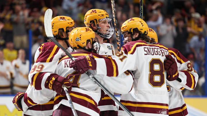 Apr 6, 2023; Tampa, Florida, USA; Minnesota defenseman Mike Koster (4) is congratulated by forward Minnesota forward Jimmy Snuggerud (81) after scoring a goal against Boston University in the first period in the semifinals of the 2023 Frozen Four college ice hockey tournament at Amalie Arena. Mandatory Credit: Nathan Ray Seebeck-Imagn Images Apr 6, 2023; Tampa, Florida, USA; Minnesota defenseman Mike Koster (4) is congratulated by forward Minnesota forward Jimmy Snuggerud (81) after scoring a goal against Boston University in the first period in the semifinals of the 2023 Frozen Four college ice hockey tournament at Amalie Arena. Mandatory Credit: Nathan Ray Seebeck-Imagn Images