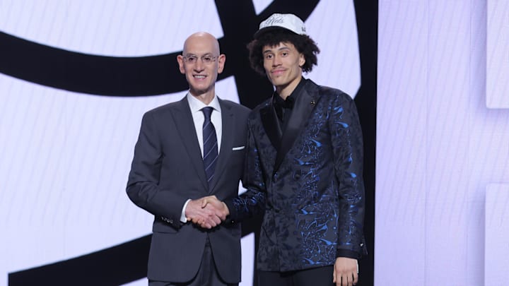 Jun 25, 2025; Brooklyn, NY, USA; Nolan Traore stands with NBA commissioner Adam Silver after being selected as the 19th pick by the Brooklyn Nets in the first round of the 2025 NBA Draft at Barclays Center. Mandatory Credit: Brad Penner-Imagn Images Jun 25, 2025; Brooklyn, NY, USA; Nolan Traore stands with NBA commissioner Adam Silver after being selected as the 19th pick by the Brooklyn Nets in the first round of the 2025 NBA Draft at Barclays Center. Mandatory Credit: Brad Penner-Imagn Images