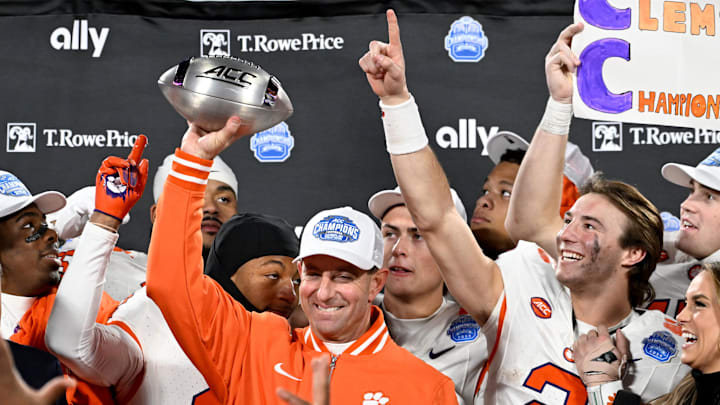 Dec 7, 2024; Charlotte, NC, USA; Clemson Tigers head coach Dabo Swinney, quarterback Cade Klubnik (2) and teammates celebrate after winning the 2024 ACC Championship game against the Southern Methodist Mustangs at Bank of America Stadium. Mandatory Credit: Bob Donnan-Imagn Images