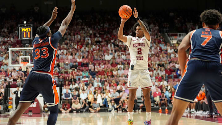 Mar 7, 2026; Tuscaloosa, AL, USA; Alabama guard Aden Holloway (2) shoots a three pointer as he is loosely defended by Auburn forward Sebastian Williams-Adams (33) at Coleman Coliseum. Alabama defeated Auburn 96-84. Mandatory Credit: Gary Cosby Jr.-Tuscaloosa News