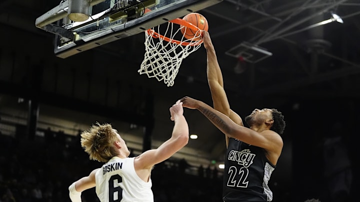 Jan 15, 2025; Boulder, Colorado, USA; Cincinnati Bearcats forward Arrinten Page (22) shoots over Colorado Buffaloes forward Trevor Baskin (6) in the first half at the CU Events Center. Mandatory Credit: Ron Chenoy-Imagn Images