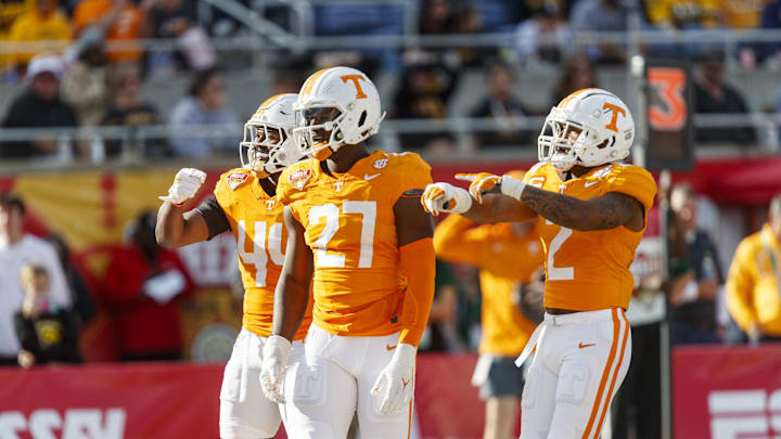 Jan 1, 2024; Orlando, FL, USA; Tennessee Volunteers defensive lineman James Pearce Jr. (27), linebacker Elijah Herring (44) and defensive back Jaylen McCollough (2) celebrate a sack against the Iowa Hawkeyes during the third quarter at Camping World Stadium. Mandatory Credit: Morgan Tencza-USA TODAY Sports