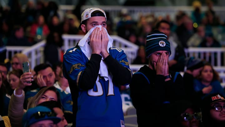 Garrett Johnson (87) and Daniel Cannady react to the sting of defeat as seconds tick off the clock during the second half Saturday, Jan 21, 2023 at TIAA Bank Field's Dream Finders Homes Flex Field at Daily's Place in Jacksonville, Fla. Thousands came out to a watch party to cheer on the Jacksonville Jaguars via big screen as they faced the Kansas City Chiefs in an AFC divisional round playoff game held at Arrowhead Stadium in Kansas City, Mo. 