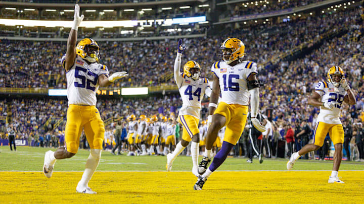 Nov 11, 2023; Baton Rouge, Louisiana, USA; LSU Tigers cornerback Jeremiah Hughes (29) and linebacker Princeton Malbrue (52) and defensive end Da'Shawn Womack (16) react to a play against the Florida Gators during the second half at Tiger Stadium. Mandatory Credit: Stephen Lew-Imagn Images Nov 11, 2023; Baton Rouge, Louisiana, USA; LSU Tigers cornerback Jeremiah Hughes (29) and linebacker Princeton Malbrue (52) and defensive end Da'Shawn Womack (16) react to a play against the Florida Gators during the second half at Tiger Stadium. Mandatory Credit: Stephen Lew-Imagn Images