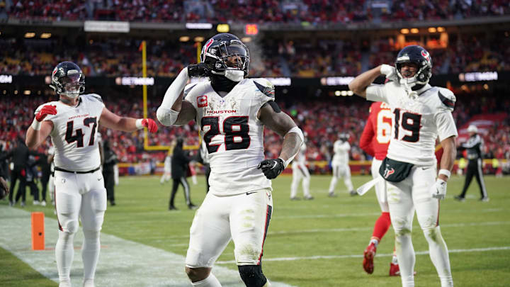 Jan 18, 2025; Kansas City, Missouri, USA; Houston Texans running back Joe Mixon (28) celebrates with fullback Andrew Beck (47) and wide receiver Xavier Hutchinson (19) after scoring a touchdown against the Kansas City Chiefs during the third quarter of a 2025 AFC divisional round game at GEHA Field at Arrowhead Stadium. Mandatory Credit: Denny Medley-Imagn Images