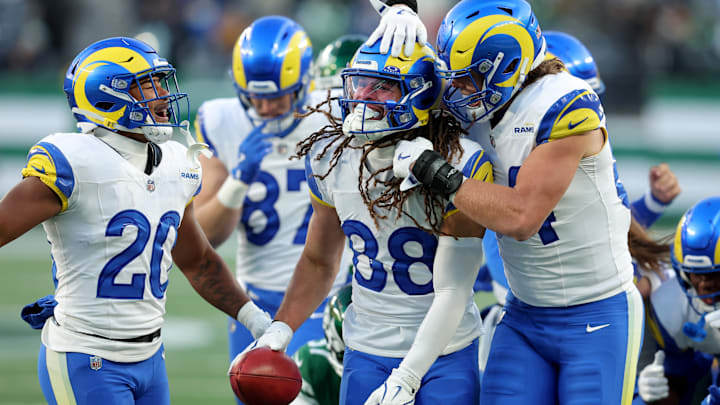 Dec 22, 2024; East Rutherford, New Jersey, USA; Los Angeles Rams wide receiver Jordan Whittington (88) celebrates with running back Ronnie Rivers (20) and tight end Hunter Long (84) after recovering the ball after a muffed punt by the New York Jets during the fourth quarter at MetLife Stadium. Mandatory Credit: Brad Penner-Imagn Images
