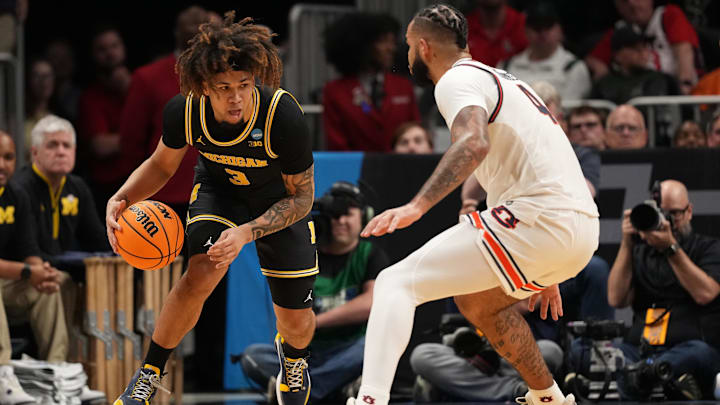 Mar 28, 2025; Atlanta, GA, USA; Michigan Wolverines guard Tre Donaldson (3) drives against Auburn Tigers forward Johni Broome (4) in the second half of a South Regional semifinal of the 2025 NCAA tournament at State Farm Arena. Mandatory Credit: Dale Zanine-Imagn Images Mar 28, 2025; Atlanta, GA, USA; Michigan Wolverines guard Tre Donaldson (3) drives against Auburn Tigers forward Johni Broome (4) in the second half of a South Regional semifinal of the 2025 NCAA tournament at State Farm Arena. Mandatory Credit: Dale Zanine-Imagn Images