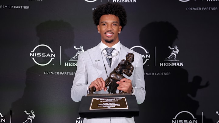 Dec 9, 2023; New York, New York, USA; LSU Tigers quarterback Jayden Daniels poses for photos with the Heisman trophy during a press conference in the Astor ballroom at the New York Marriott Marquis after winning the Heisman trophy. Mandatory Credit: Brad Penner-Imagn Images