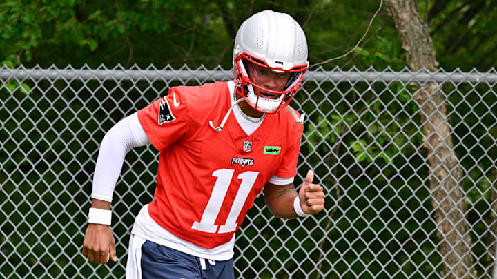 Jun 9, 2025; Foxborough, MA, USA; New England Patriots quarterback Joshua Dobbs (11) jogs to the practice fields at Gillette Stadium. Mandatory Credit: Eric Canha-Imagn Images