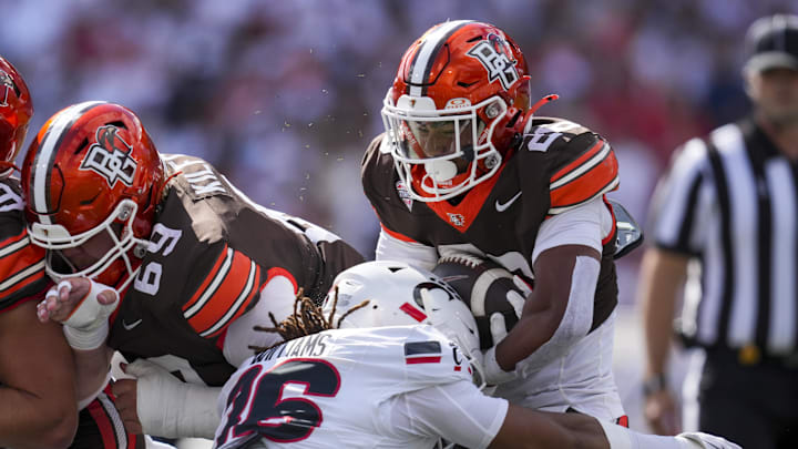 Sep 6, 2025; Cincinnati, Ohio, USA; Bowling Green Falcons running back Cameron Pettaway (26) carries the ball as he is tackled by Cincinnati Bearcats safety Xavier Williams (36) in the first half at Nippert Stadium. Mandatory Credit: Aaron Doster-Imagn Images
