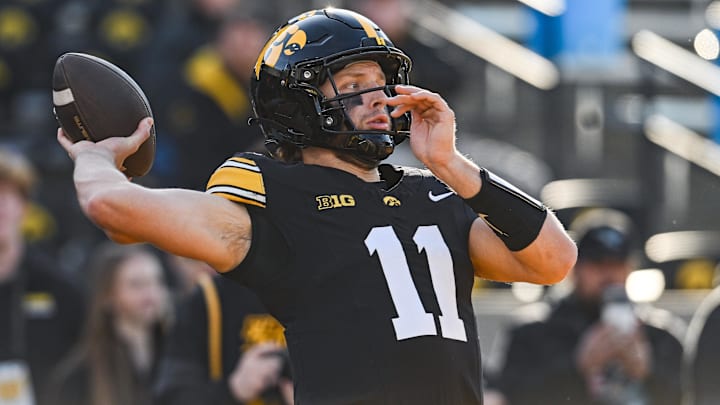 Nov 22, 2025; Iowa City, Iowa, USA; Iowa Hawkeyes quarterback Mark Gronowski (11) warms up before the game against the Michigan State Spartans at Kinnick Stadium. Mandatory Credit: Jeffrey Becker-Imagn Images