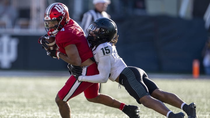 Nov 18, 2023; Bloomington, Indiana, USA; Indiana Hoosiers wide receiver DeQuece Carter (4) is tackled by Michigan State Spartans defensive back Angelo Grose (15) during the second half at Memorial Stadium. Mandatory Credit: Marc Lebryk-USA TODAY Sports Nov 18, 2023; Bloomington, Indiana, USA; Indiana Hoosiers wide receiver DeQuece Carter (4) is tackled by Michigan State Spartans defensive back Angelo Grose (15) during the second half at Memorial Stadium. Mandatory Credit: Marc Lebryk-USA TODAY Sports