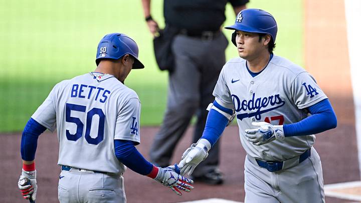May 20, 2026; San Diego, California, USA; Los Angeles Dodgers designated hitter Shohei Ohtani (17) is congratulated by shortstop Mookie Betts (50) after hitting a solo home run during the first inning as San Diego Padres third baseman Manny Machado (13) looks on at Petco Park. Mandatory Credit: Denis Poroy-Imagn Images May 20, 2026; San Diego, California, USA; Los Angeles Dodgers designated hitter Shohei Ohtani (17) is congratulated by shortstop Mookie Betts (50) after hitting a solo home run during the first inning as San Diego Padres third baseman Manny Machado (13) looks on at Petco Park. Mandatory Credit: Denis Poroy-Imagn Images