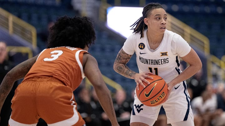 Dec 1, 2024; Estero, FL, USA; West Virginia University JJ Quinerly (11) looks to pass the ball while defended by University of Texas Rori Harmon (3) during the first quarter of the Women's Gulf Coast Showcase at Hertz Arena. Mandatory Credit: Chris Tilley-Imagn Images
