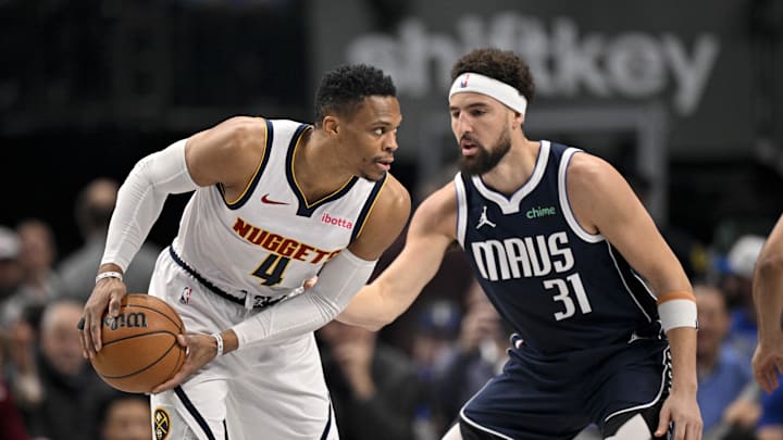 Jan 12, 2025; Dallas, Texas, USA; Denver Nuggets guard Russell Westbrook (4) looks to moves the ball past Dallas Mavericks guard Klay Thompson (31) during the first quarter at the American Airlines Center. Mandatory Credit: Jerome Miron-Imagn Images