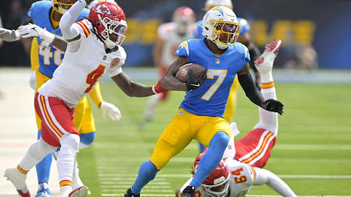 Sep 29, 2024; Inglewood, California, USA;  Los Angeles Chargers cornerback Kristian Fulton (7) avoids a tackle by Kansas City Chiefs offensive tackle Wanya Morris (64) after an interception in the first half at SoFi Stadium. Mandatory Credit: Jayne Kamin-Oncea-Imagn Images