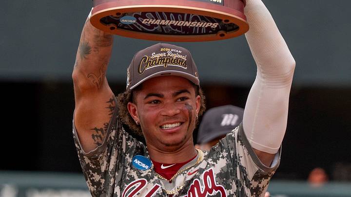 Jun 8, 2026; Tuscaloosa, AL, USA; The Crimson Tide players and coaches celebrate their 7-2 win over St. John’s to earn a trip to the College World Series. Alabama shortstop Justin Lebron (1) holds the trophy up to show to the fans. Jun 8, 2026; Tuscaloosa, AL, USA; The Crimson Tide players and coaches celebrate their 7-2 win over St. John’s to earn a trip to the College World Series. Alabama shortstop Justin Lebron (1) holds the trophy up to show to the fans.