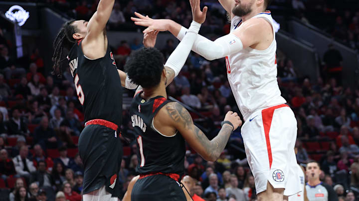 Mar 20, 2024; Portland, Oregon, USA; LA Clippers center Ivica Zubac (40) shoots the ball over Portland Trail Blazers guard Dalano Banton (5) and Portland Trail Blazers guard Anfernee Simons (1) in the second quarter at Moda Center. Mandatory Credit: Jaime Valdez-Imagn Images Mar 20, 2024; Portland, Oregon, USA; LA Clippers center Ivica Zubac (40) shoots the ball over Portland Trail Blazers guard Dalano Banton (5) and Portland Trail Blazers guard Anfernee Simons (1) in the second quarter at Moda Center. Mandatory Credit: Jaime Valdez-Imagn Images