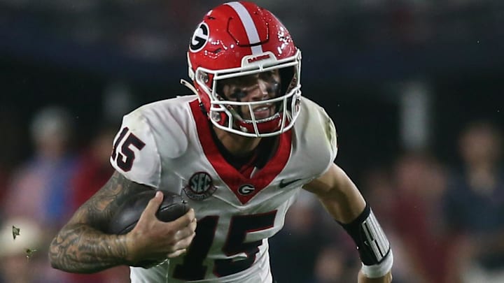 Georgia Bulldogs quarterback Carson Beck (15) runs the ball during the second half against the Mississippi Rebels at Vaught-Hemingway Stadium.