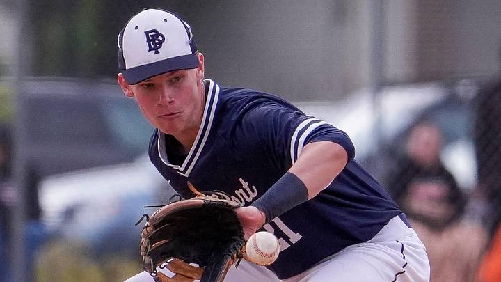 Bay Port High School's Cayden Heier (21) fields a ground ball versus West De Pere in a Fox River Classic Conference game on May 22, 2026. Bay Port High School's Cayden Heier (21) fields a ground ball versus West De Pere in a Fox River Classic Conference game on May 22, 2026.