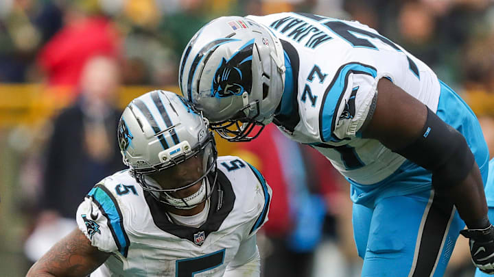 Carolina Panthers running back Rico Dowdle (5) and offensive tackle Yosh Nijman (77) celebrate after Dowdle runs for a first down to set up a game-winning field goal against the Green Bay Packers on Sunday, November 2, 2025, at Lambeau Field in Green Bay, Wis. The Panthers won the game, 16-13, on a 49-yard field goal as time expired.
Tork Mason/USA TODAY NETWORK-Wisconsin