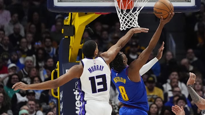 Jan 23, 2025; Denver, Colorado, USA; Sacramento Kings forward Keegan Murray (13) fouls Denver Nuggets forward Peyton Watson (8) in the second half at Ball Arena. Mandatory Credit: Ron Chenoy-Imagn Images