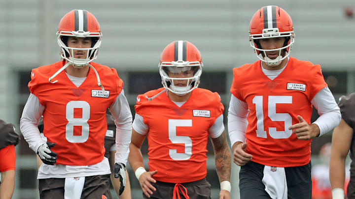 Cleveland Browns quarterbacks Kenny Pickett, Dillon Gabriel, and Joe Flacco warm up during OTAs