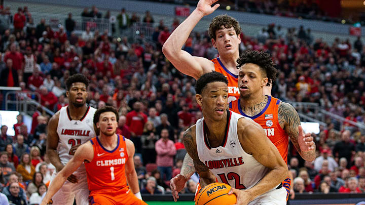 Louisville forward JJ Traynor (12) faced a double-team during first half action as the Cardinal's