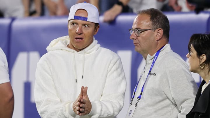 Sep 21, 2024; Provo, Utah, USA; Brigham Young Cougars alumni and Utah Jazz owner Ryan Smith speaks with Adrian Wojnarowski in the game against the Kansas State Wildcats at LaVell Edwards Stadium.