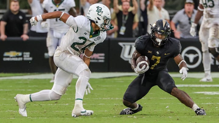 Sep 30, 2023; Orlando, Florida, USA; UCF Knights running back RJ Harvey (7) runs the ball against Baylor Bears safety Corey Gordon Jr. (24) during the second half at FBC Mortgage Stadium. Mandatory Credit: Mike Watters-USA TODAY Sports