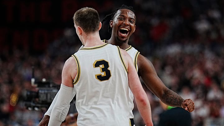Purdue guard Lance Jones (55) celebrates a three-point basket by guard Braden Smith (3) 