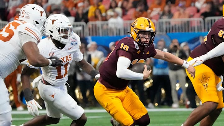 Arizona State quarterback Sam Leavitt (10) scrambles away from Texas linebacker Colin Simmons (11) during the second quarter of the Chick-fil-A Peach Bowl in Atlanta on Wednesday, Jan. 1, 2025.